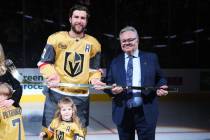 Vegas Golden Knights defenseman Alex Pietrangelo is presented with a gold stick from General Ma ...
