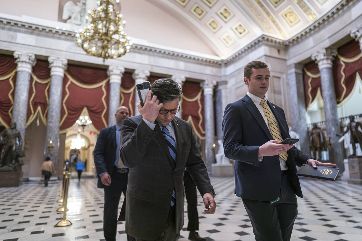 House Speaker Mike Johnson, R-La., walks through Statuary Hall as lawmakers gather in the House ...