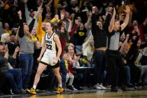 Iowa guard Caitlin Clark (22) reacts after breaking the NCAA women's career scoring record duri ...