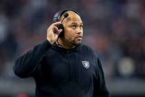 Raiders interim head coach Antonio Pierce adjusts his headset during the first half of an NFL g ...