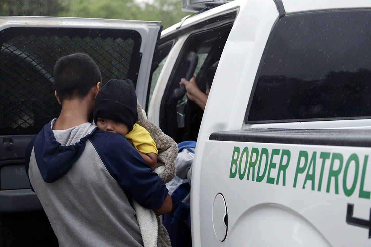 Families who crossed the nearby U.S.-Mexico border near McAllen, Texas are placed in a Border P ...