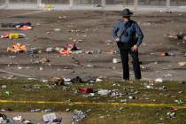 A law enforcement officer looks around the scene following a shooting at the Kansas City Chiefs ...