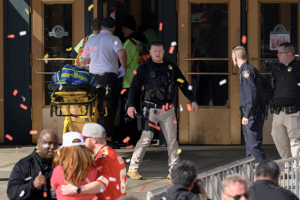 Emergency personnel, left, take a stretcher into Union Station following a shooting at the Kans ...