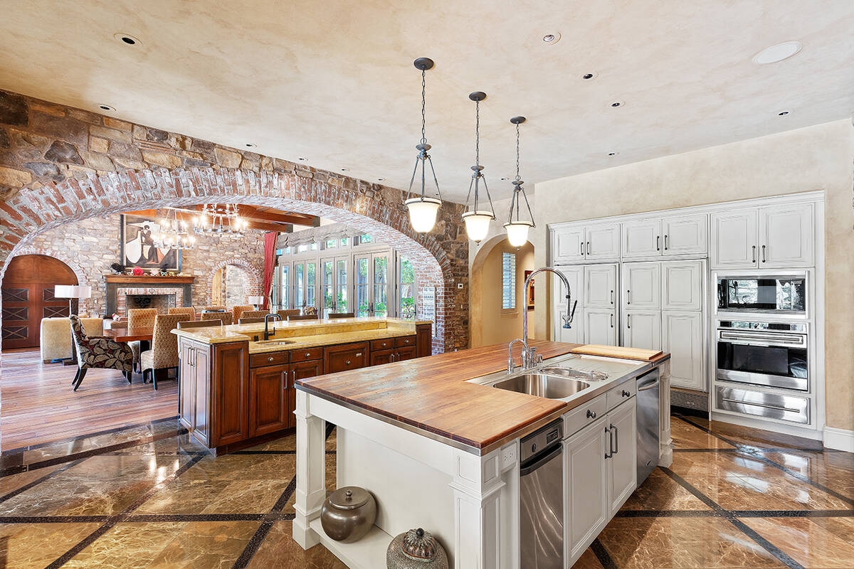 The kitchen features a large center island. (IS Luxury)