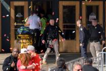 Emergency personnel, left, take a stretcher into Union Station following a shooting at the Kans ...
