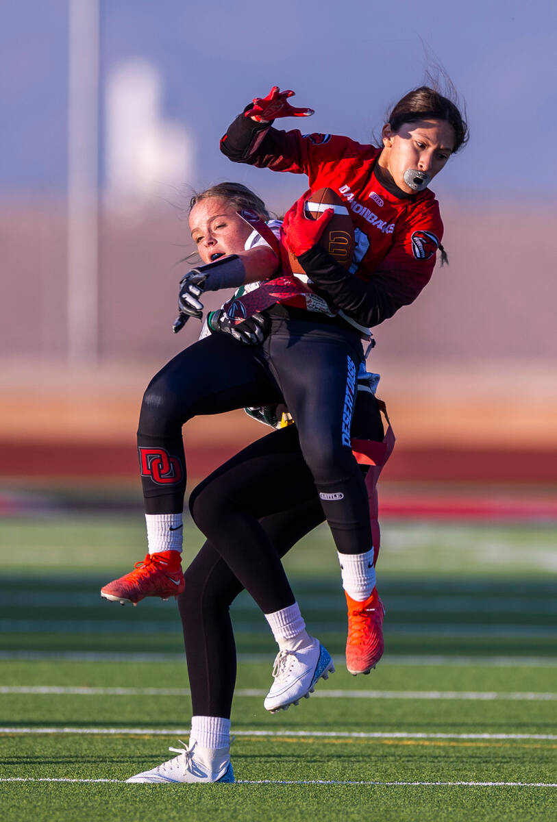 Desert Oasis receiver Erica Moreno (13) elevates for a catch over Palo Verde defender Samantha ...