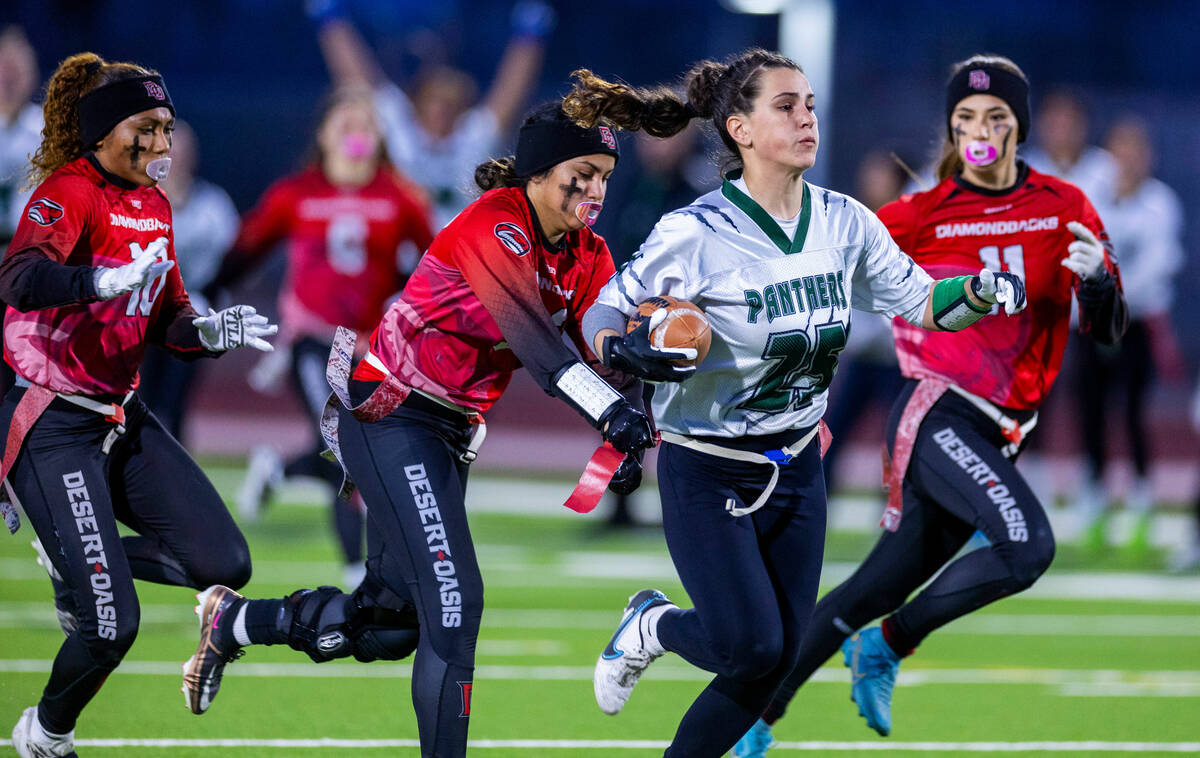 Palo Verde receiver Olivia Perkins (25) makes a long catch while being chased by Desert Oasis d ...