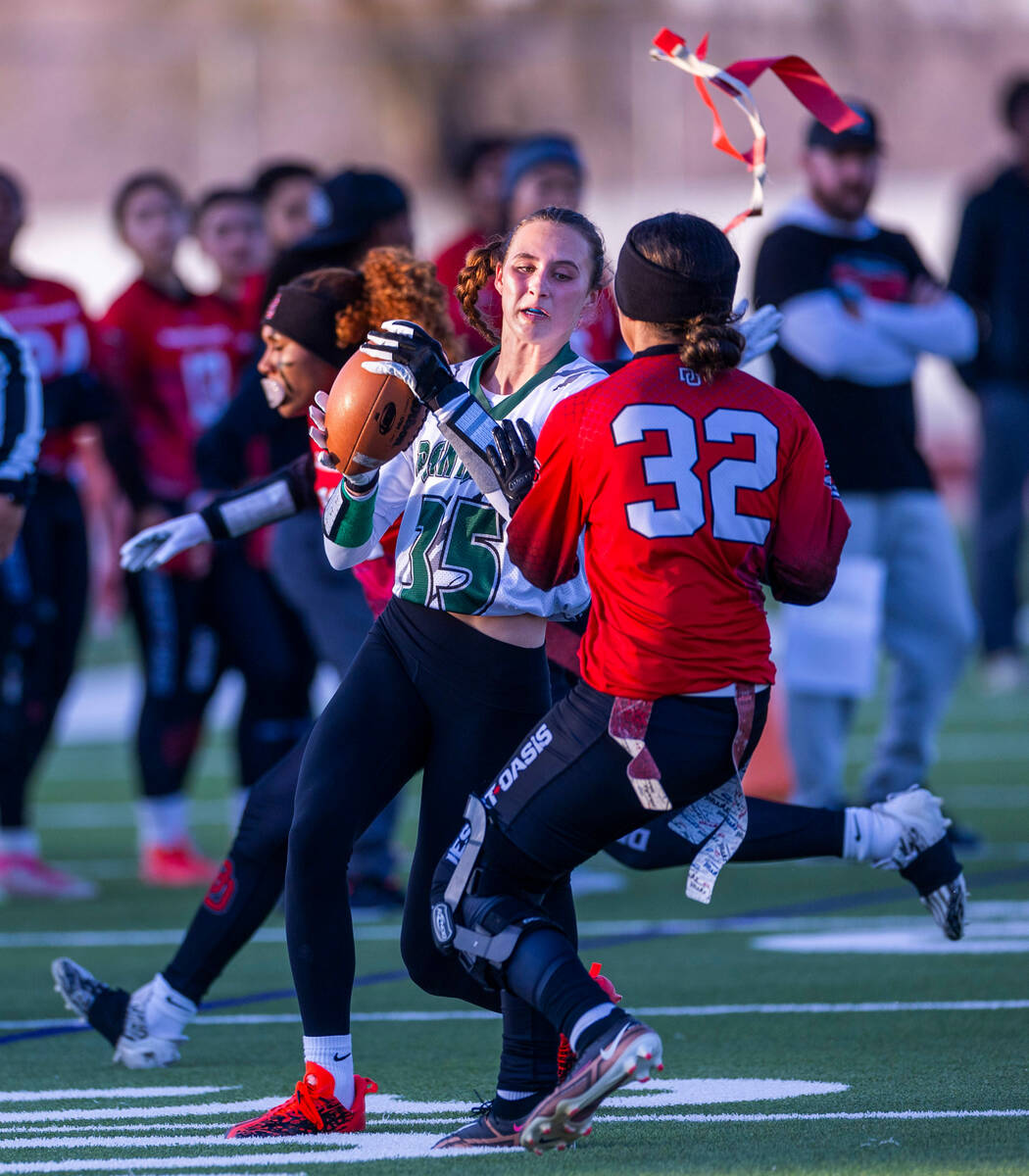 Palo Verde running back Tia Brown (35) has her flag pulled by Desert Oasis defender Brooklin Hi ...