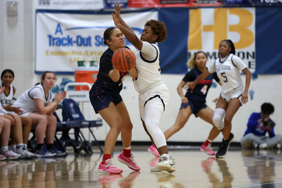 Liberty's Alofa Eteuini (3) passes with pressure from Shadow Ridge guard Jada Livingston (15) d ...