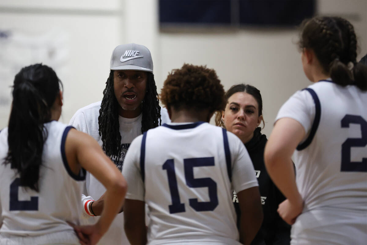 Shadow Ridge head coach Johnny Wheeler and assistant coach Jennifer Wheeler conduct a timeout d ...