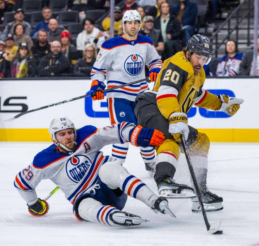 Edmonton Oilers center Leon Draisaitl (29) takes out Golden Knights center Chandler Stephenson ...