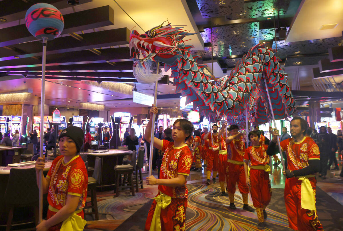 A giant dragon winds it's way through the crowd as members of Yau Kung Moon perform the Chinese ...