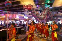 A giant dragon winds it's way through the crowd as members of Yau Kung Moon perform the Chinese ...