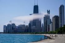The Chicago city skyline is covered by the fog lifted off Lake Michigan on Aug. 5, 2022, in Chi ...