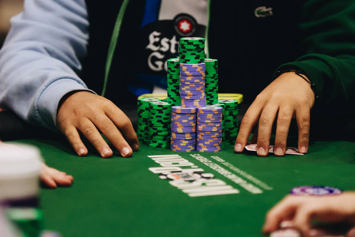 A poker player stacks their chips during the World Series of Poker $10,000 buy-in no No-limit H ...