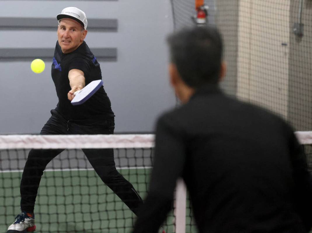 Phil Wexler, 58, of Miami, facing, plays against Leslie Lau, 51, of Canada at Vegas Indoor Pick ...