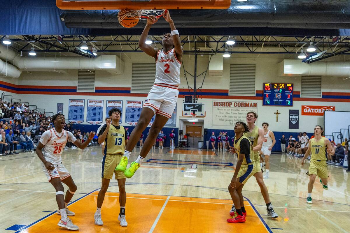 Bishop Gorman's Jett Washington (2) dunks the ball as Foothill's Branden Castro (13) and teamma ...