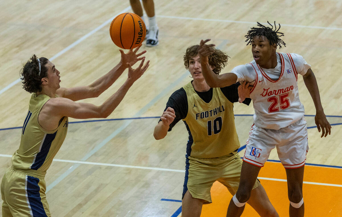 Foothill's Zak Abdalla (11) grabs a rebound with help from teammate Corbin Putnam (10) as Bisho ...