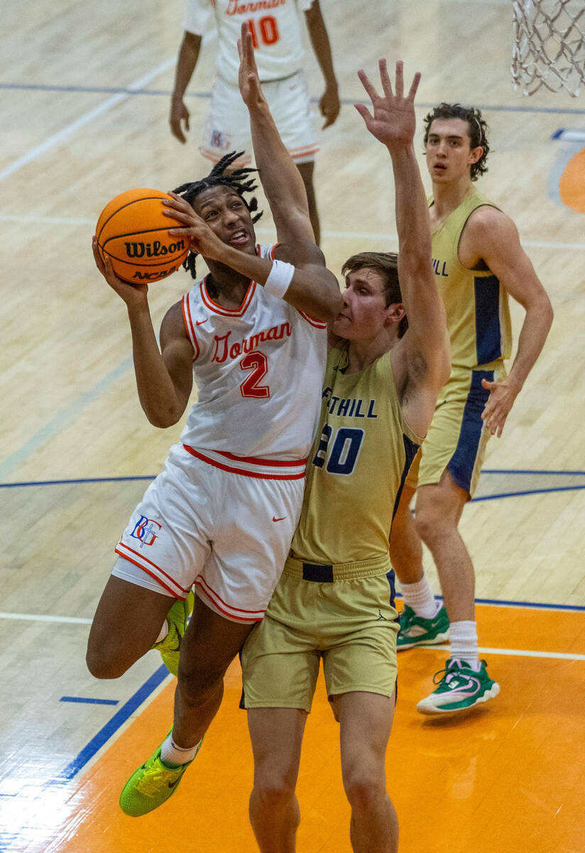 Bishop Gorman's Jett Washington (2) elevates to the basket over Foothill's Brock Stearman (20) ...