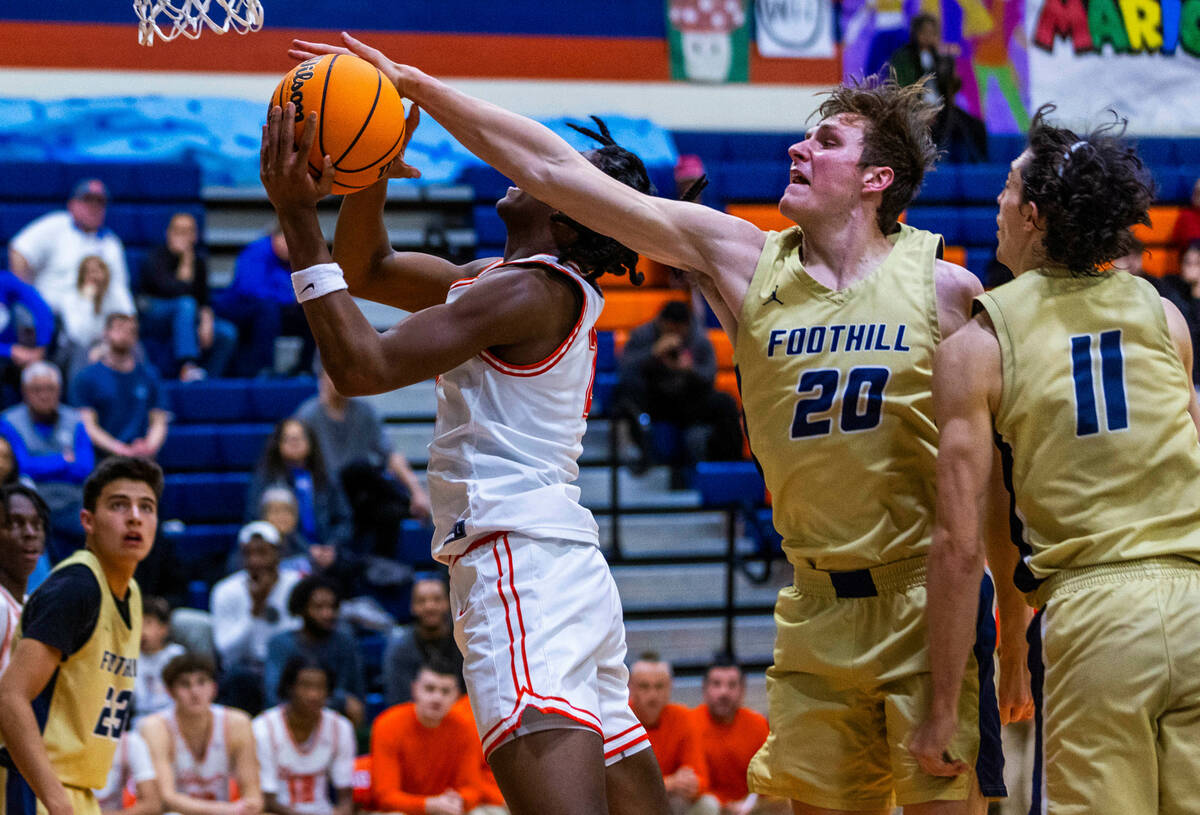 Bishop Gorman's Jett Washington (2) has a shot attempt rejected on a drive by Foothill's Brock ...