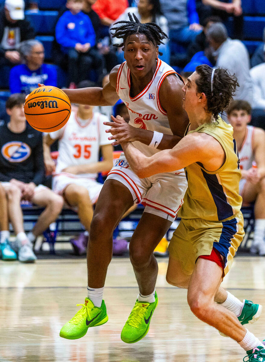 Bishop Gorman's Jett Washington (2) drives hard against Foothill's Zak Abdalla (11) during the ...