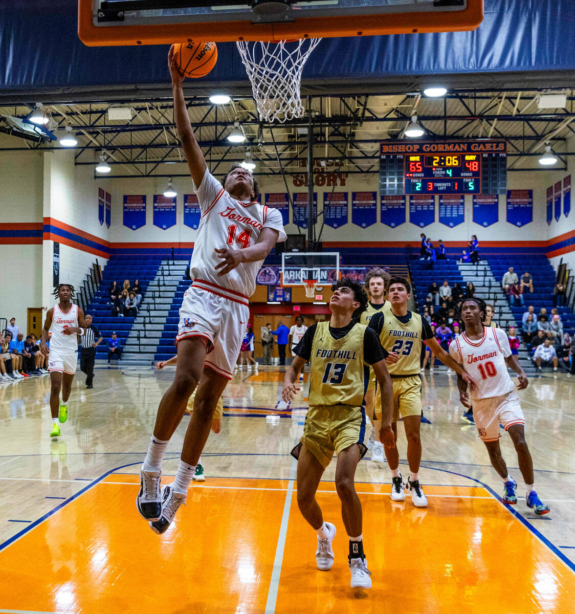 Bishop Gorman's Kameron Cooper (14) lays in a fast break over Foothill's Branden Castro (13) du ...