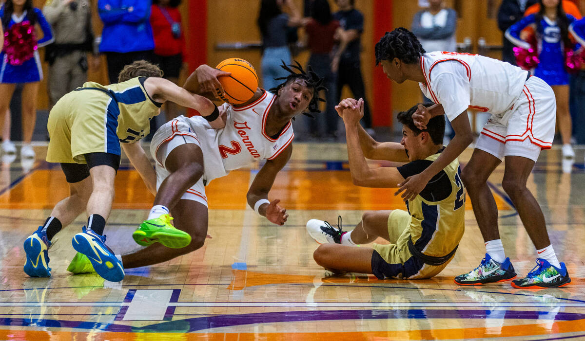 Bishop Gorman's Jett Washington (2) battles for a loose ball with Foothill's Christopher Natale ...