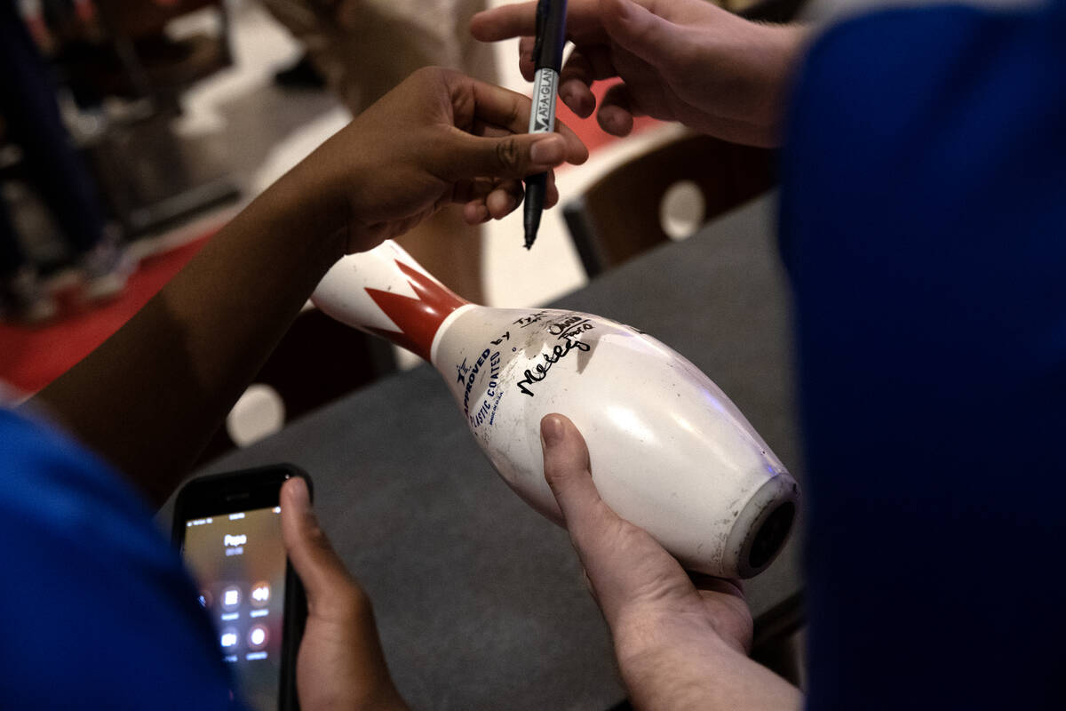 Bowlers sign a pin after the NIAA high school state bowling championships at The Orleans on Fri ...