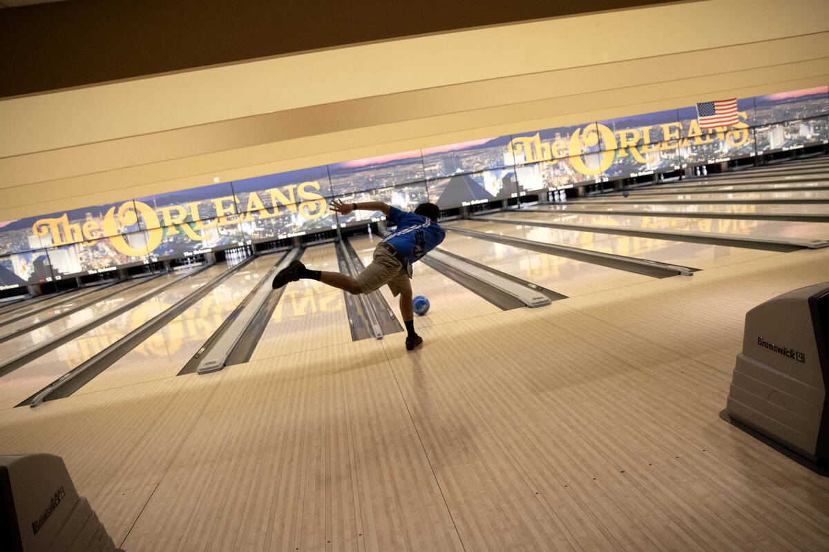 A bowler sends the ball up the lane during the NIAA high school state bowling championships at ...
