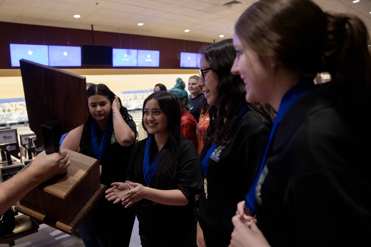 Green Valley girls team accepts their trophy after winning the Class 4A state bowling champions ...