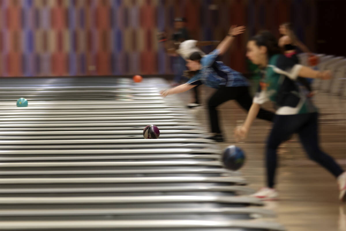 Bowlers deliver balls during the NIAA high school state bowling championships at The Orleans on ...