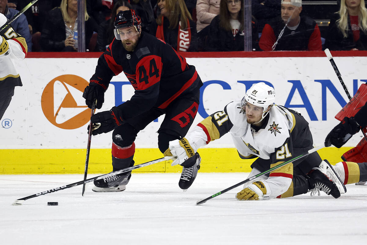 Carolina Hurricanes' Calvin de Haan (44) and Vegas Golden Knights' Brett Howden (21) battle for ...