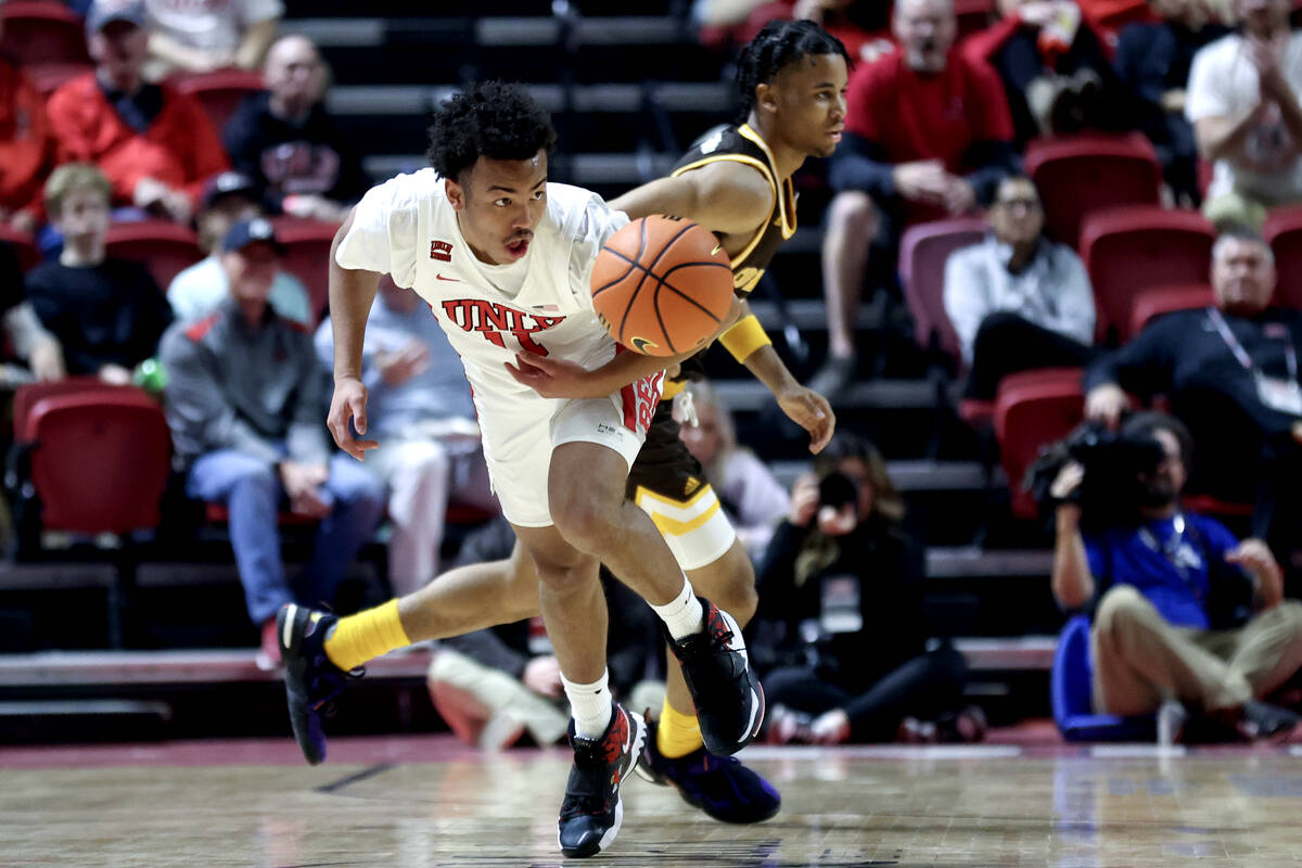 UNLV Rebels guard Dedan Thomas Jr. (11) heads up the court after stealing the ball from Wyoming ...