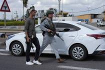 Plainclothes Israeli security forces investigate the site of a shooting attack at the Masmiya-R ...