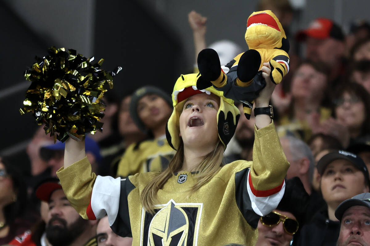 A Golden Knights fan cheers for her team during the second period of an NHL hockey game against ...