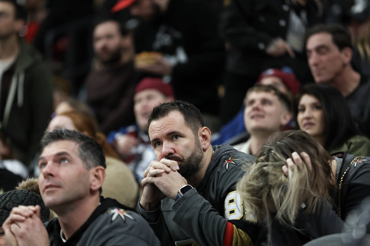 Golden Knights fans react after the Hurricanes scored during the third period of an NHL hockey ...