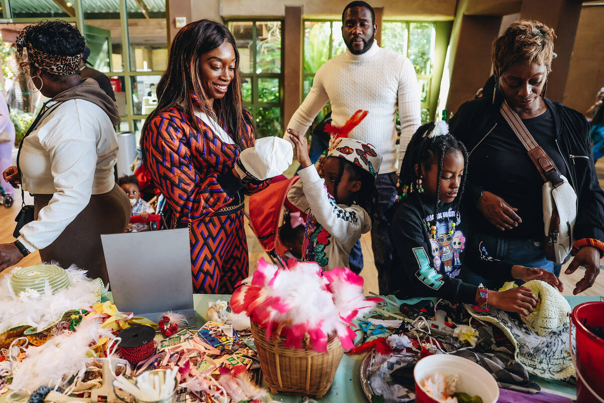 Attendees make hats at a craft table at the Springs Preserve’s 15th annual Black History ...
