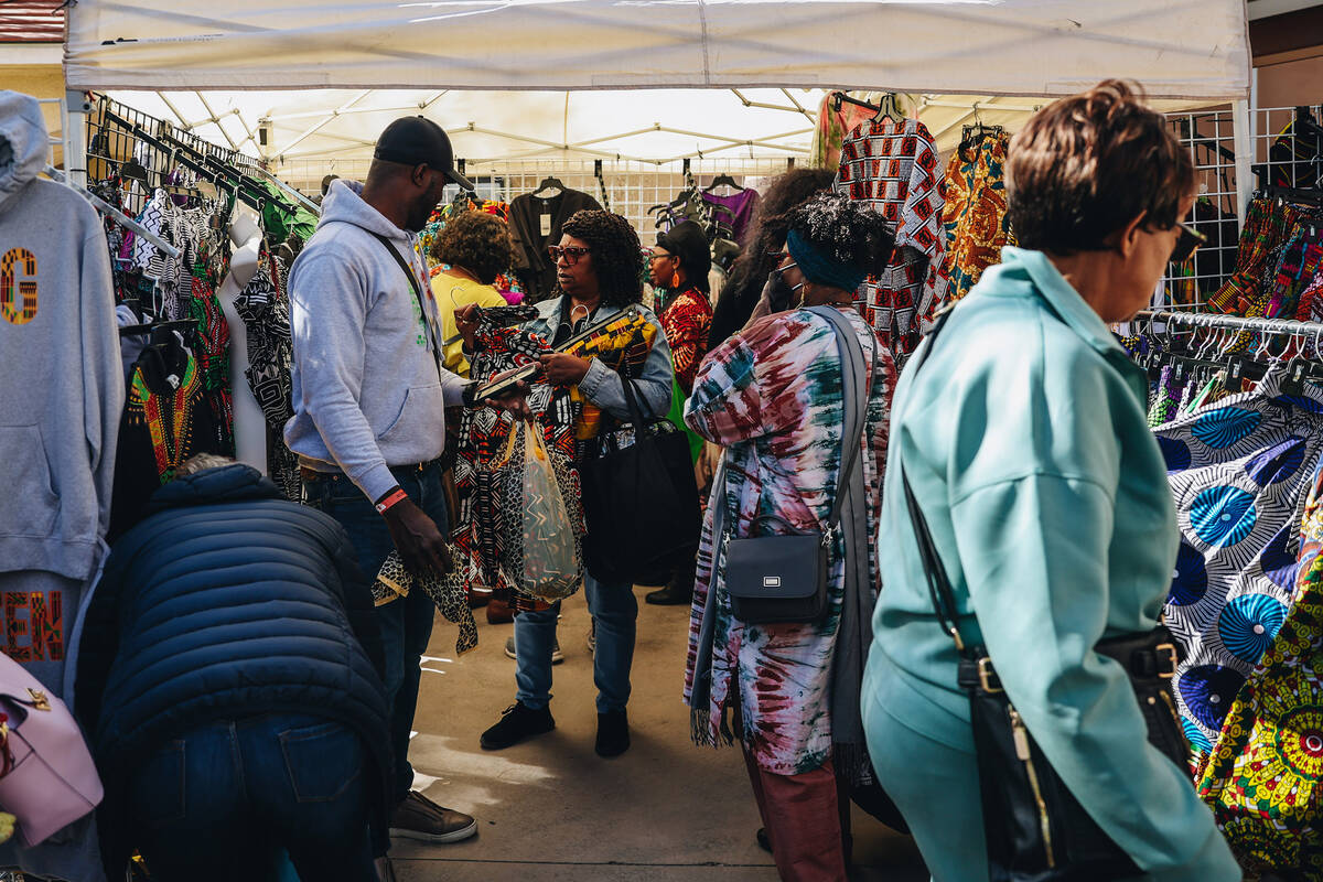 Attendees look at clothing for sale at the Springs Preserve’s 15th annual Black History ...