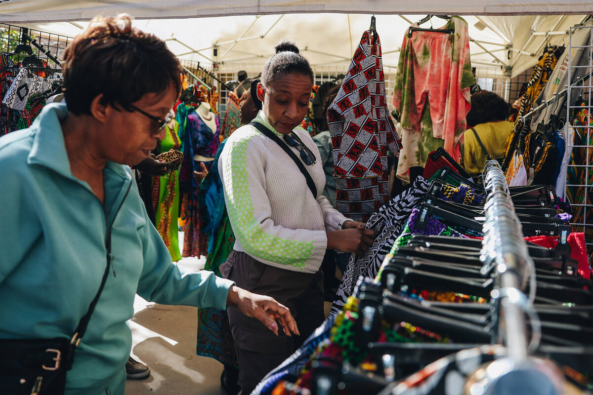 Attendees look at clothing for sale at the Springs Preserve’s 15th annual Black History ...