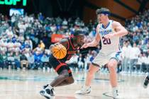 San Diego State guard Darrion Trammell (12) drives past Colorado State guard Joe Palmer (20) in ...