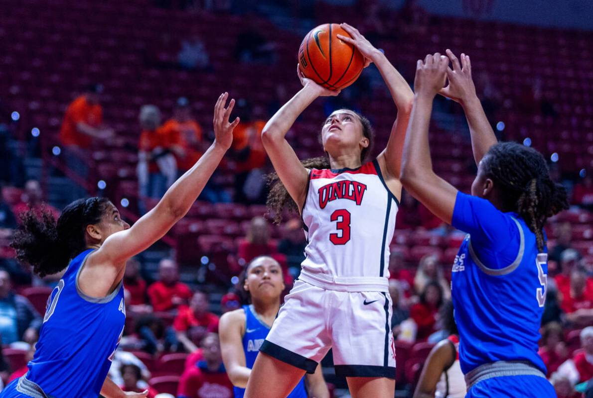UNLV Lady Rebels guard Kiara Jackson (3) elevates for a shot between Air Force Falcons guard Ja ...