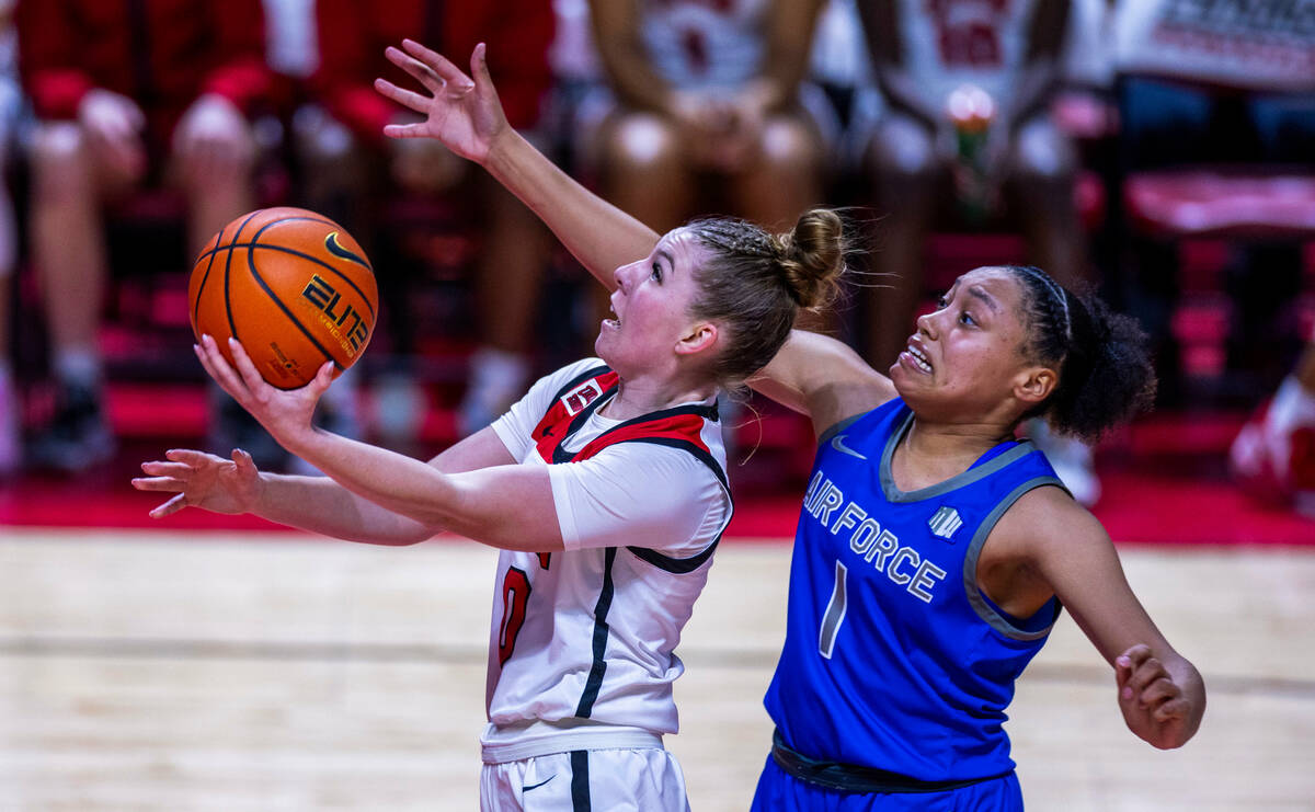 UNLV Lady Rebels guard Ashley Scoggin (0) gets inside of Air Force Falcons guard Alexis Cortez ...