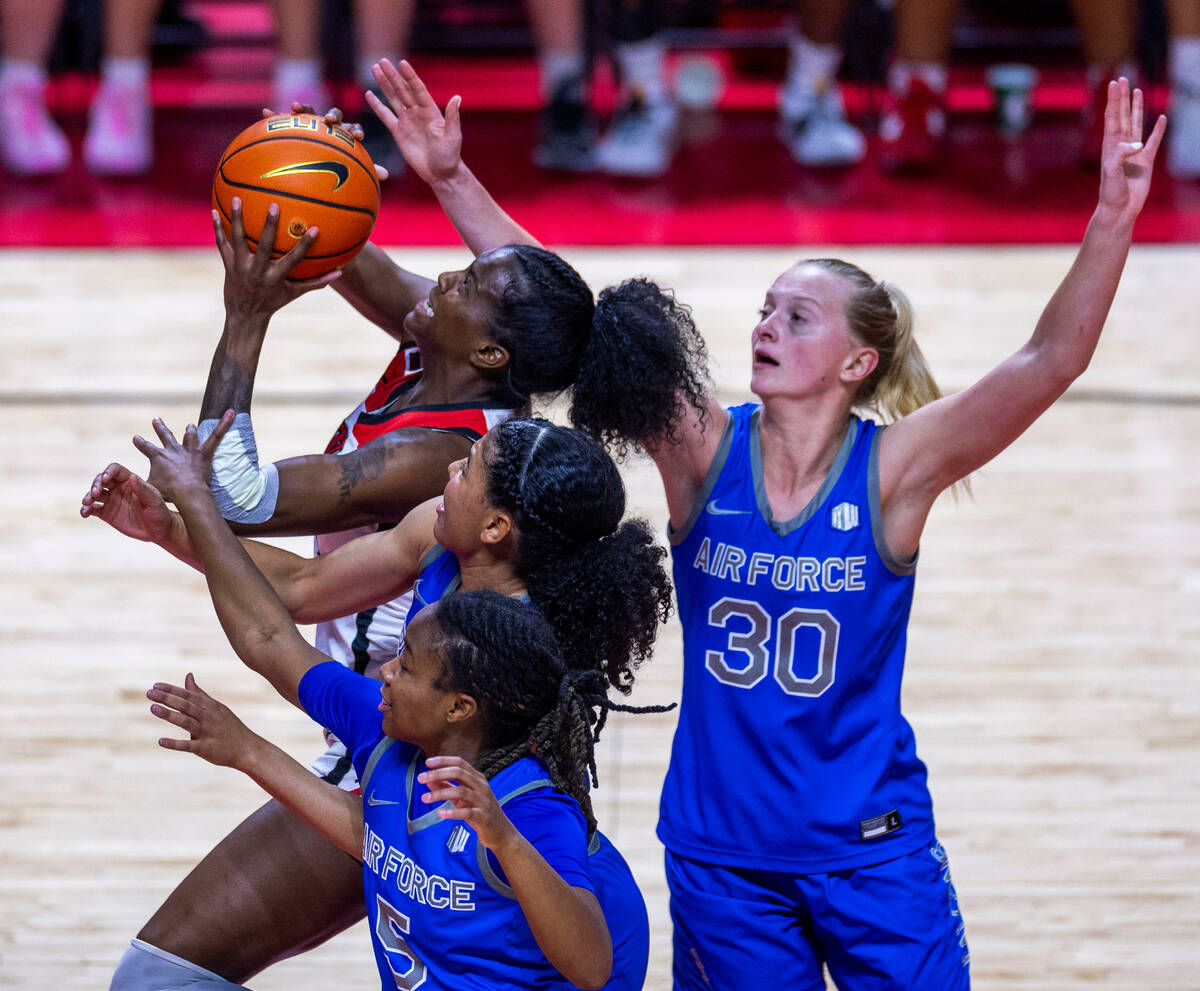 UNLV Lady Rebels center Desi-Rae Young (23) battles past Air Force Falcons guard Jayda McNabb ...