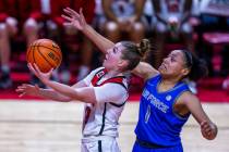 UNLV Lady Rebels guard Ashley Scoggin (0) gets inside of Air Force Falcons guard Alexis Cortez ...