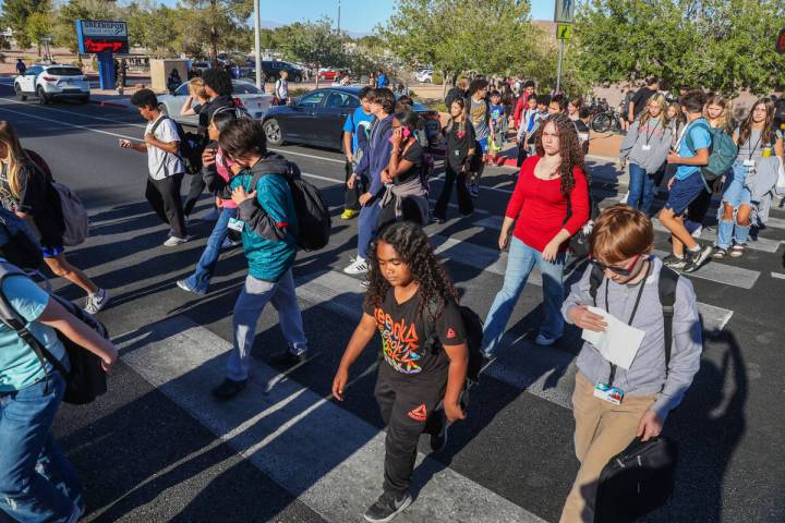 Middle school children cross Valle Verde Drive as they leave Greenspun Junior High School on No ...