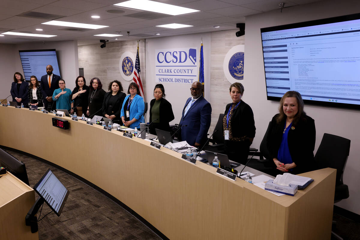 The Clark County School Board members stand as the honor guard arrives with the colors during a ...