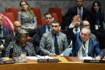 Algerian Ambassador to the United Nations Amar Bendjama, right, votes to approve a resolution c ...