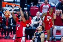 UNLV Rebels forward Rob Whaley Jr. (5) dunks the ball as UNR forward K.J. Hymes (42) looks on d ...