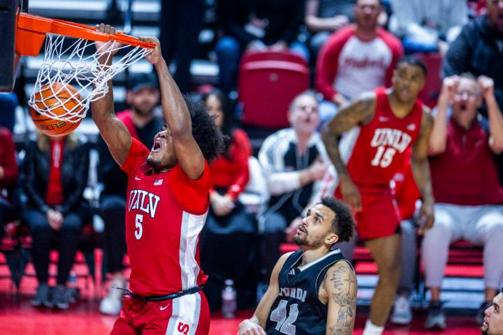 UNLV Rebels forward Rob Whaley Jr. (5) dunks the ball as UNR forward K.J. Hymes (42) looks on d ...