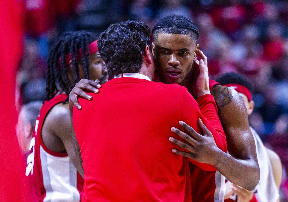 UNLV Rebels guard Luis Rodriguez (15) is counseled by a coach against UNR during the second hal ...